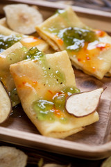Close-up of crapes with fruit sauce topping, selective focus, vertical shot