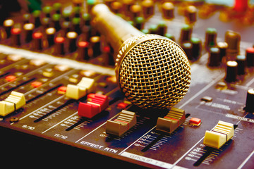 Microphone with audio mixer in the control room audio system.