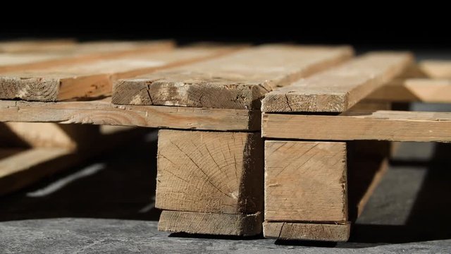 Close-up of wooden pallet. Angle of wooden pallet on grey concrete floor. Production of furniture using pallets