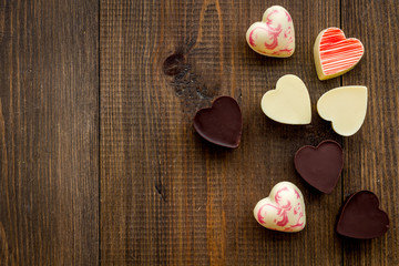Heart-shaped confection for Valentine's day on dark wooden background top view copy space