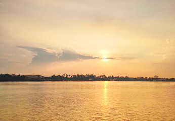 Tranquil Scenery of River and Silhouette of Trees and Buildings During Sunset