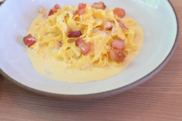 fettucine white cream sauce in white plate.