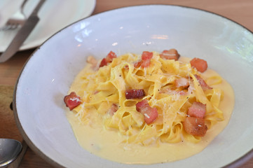 fettucine white cream sauce in white plate.