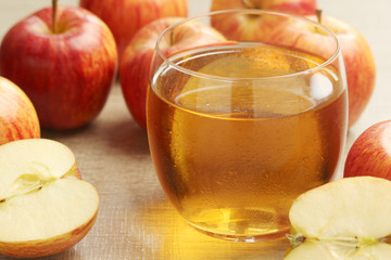 A glass with juice and apples	