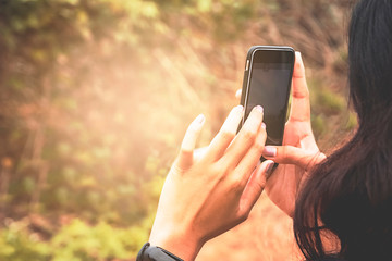 Women's Hand Catching Mobile phone Save images and video clips.