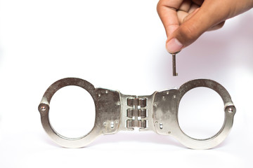 Handcuff with key on white background