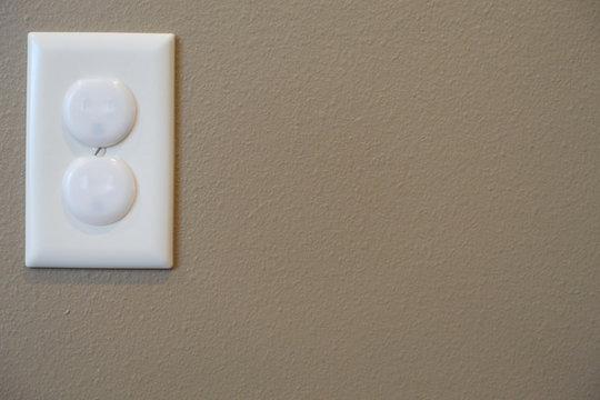 Child proofed covered electrical outlet