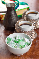 Traditional turkish coffee and turkish delight on wooden background.