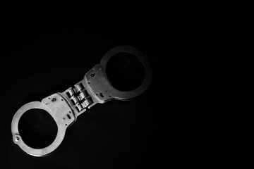 old handcuff on table in white tone, criminal justice concept