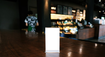 Menu frame standing on wood table in Bar restaurant cafe. space for text marketing promotion.