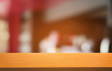 Empty dark wooden table in front of abstract blurred bokeh background of restaurant . can be used for display or montage your products.Mock up for space.