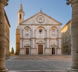Fototapeta na wymiar Pio II square and the Duomo of Pienza framed by the columns of the town hall, Siena, Tuscany, Italy