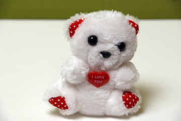 White bear with a heart on a white background isolated.