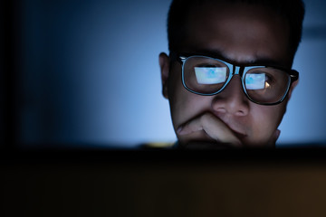 Focused and serious looking man working and thinking hard on computer © amenic181