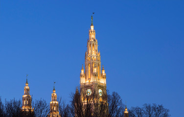 Fototapeta premium Vienna, Austria, town hall building in the evening. The building is built in the neo-Gothic style with a symmetrical main facade. The main facade of the town hall has 5 towers.