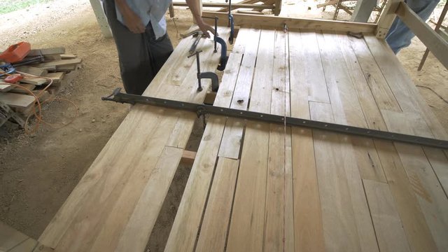 Carpenter making wooden bed.