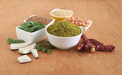 Curry leaves chutney powder, an Indian vegetarian side dish for items like idli, dosa, roti, and rice, and some of its main ingredients.