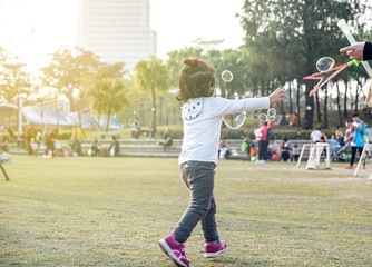 Children playing with bubbles in the park