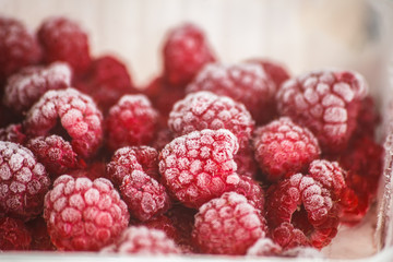 Frozen raspberries, covered with hoarfrost. Macro photo