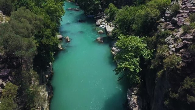Aerial, drone shot, over a old, roman, stone bridge, the Oluk kopru and a turquoise, Koprucay river, on a sunny, summer day, in Koprulu Canyon National Park, in Antalaya, Turkey