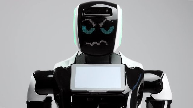 portrait of a modern robot with an electronic face. Modern Robotic Technologies. The robot looks into the camera with evil eyes. Exhibits aggressive emotions, wants to kill man.