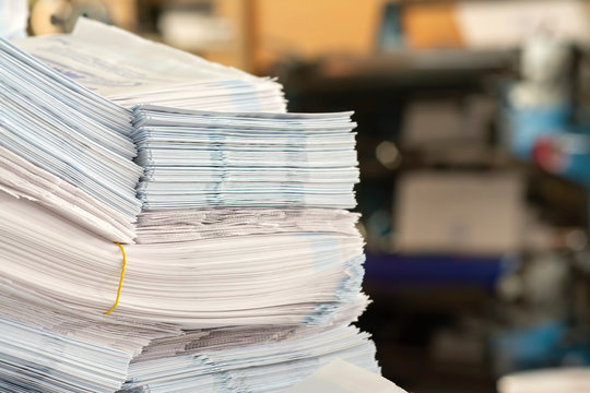 stack of paper bags on table in print shop.