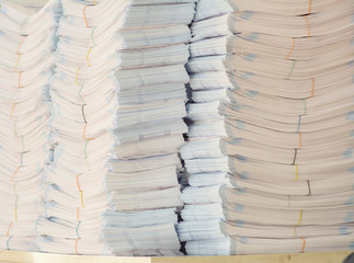 stack of paper bags on table in print shop.