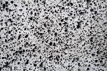 Abstract pattern on the surface of the briquette made of foamed concrete as a background. The...