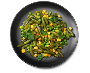 cut green beans, green peas and corn at black plate isolated on white background. top view. healthy food