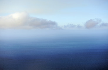 morning view of the ocean at the level of clouds