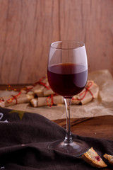 Delicious biscotti cookies with dried cherries and hazelnuts. Organic style. A glass of red wine.