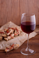 Delicious biscotti cookies with dried cherries and hazelnuts. Organic style. A glass of red wine.