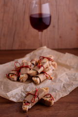Delicious biscotti cookies with dried cherries and hazelnuts. Organic style. A glass of red wine.