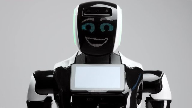portrait of a modern robot with an electronic face. Modern Robotic Technologies. The robot looks into the camera with big cheerful eyes. Laughing electronic person
