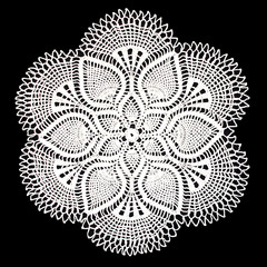 Isolated crocheted white doily with a pattern of cones on a black background. Round decorative doily. - obrazy, fototapety, plakaty