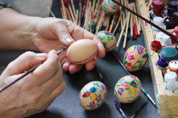 Fototapeta na wymiar handmade painted easter eggs hands of a woman