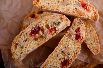 Delicious biscotti cookies with dried cherries and hazelnuts with black tea and white cup. Organic style. White cup of tea.
