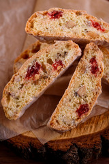 Delicious biscotti cookies with dried cherries and hazelnuts with black tea and white cup. Organic style. White cup of tea.