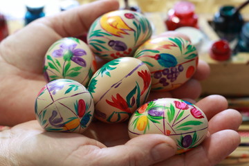 Fototapeta na wymiar painted eggs in the hand of a woman
