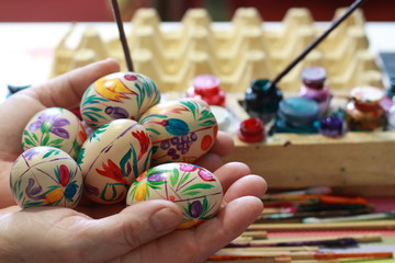 painted eggs in the hand of a woman