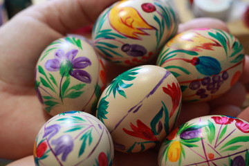 painted eggs in the hand of a woman