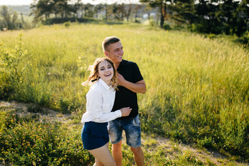 Fototapeta premium Portrait of a happy young couple enjoying a day in the park together