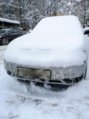 Auto covered with snow in winter