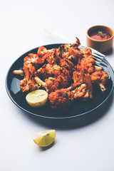 Tandoori Gobi / Roasted cauliflower Tikka is a dry dish made by roasting Cauliflowers in Oven/Tandoor. It's  popular starter food from India. served with ketchup. selective focus