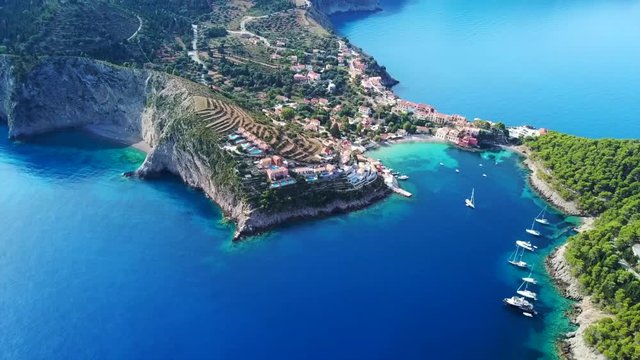 Aerial drone bird's eye view video of beautiful and picturesque colorful traditional fishing village of Assos in island of Cefalonia, Ionian, Greece