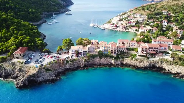 Aerial drone bird's eye view video of beautiful and picturesque colorful traditional fishing village of Assos in island of Cefalonia, Ionian, Greece