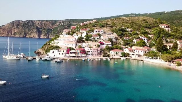 Aerial drone bird's eye view video of beautiful and picturesque colorful traditional fishing village of Assos in island of Cefalonia, Ionian, Greece