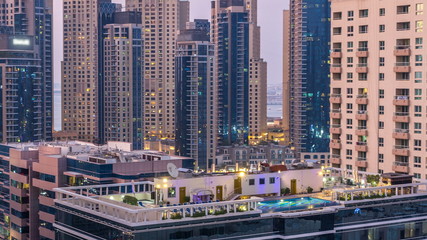 Fototapeta na wymiar Aerial view of Dubai Marina after sunset from a vantage point day to night timelapse.