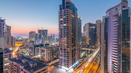 Fototapeta na wymiar Aerial view of Dubai Marina after sunset from a vantage point day to night timelapse.