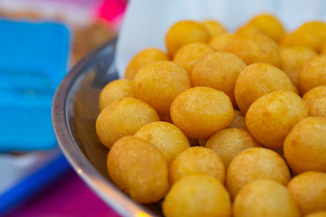Close-up of fried sweet potato balls.